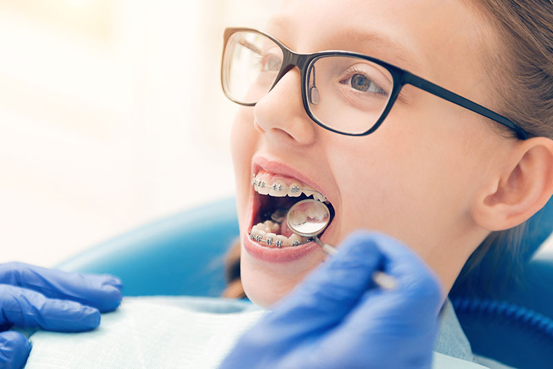 child with braces getting a checkup