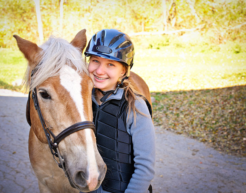 girl hugging a horse